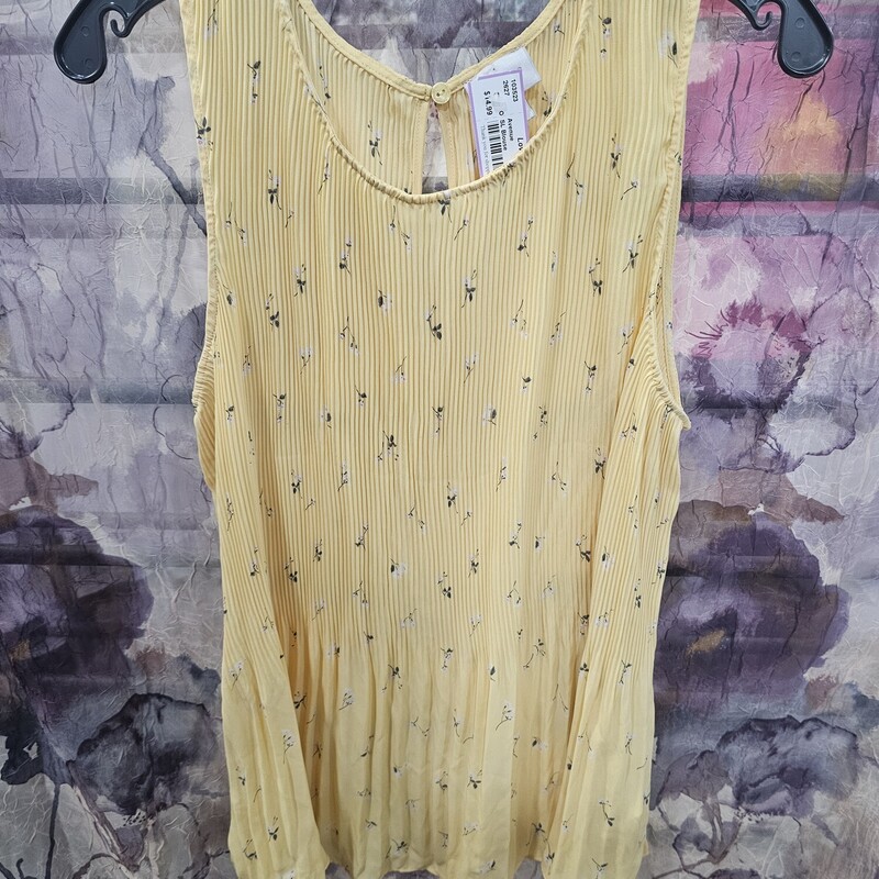 Brand new without tags - this sleeveless blouse is done in a pleated style in yellow with subtle white floral print.