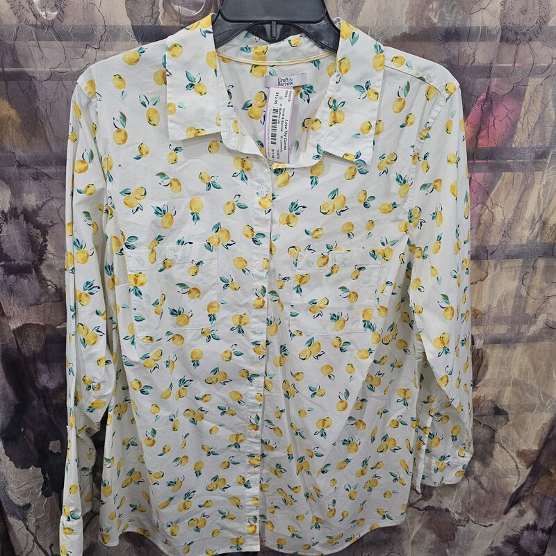 Super cute and fun button up blouse in white with yellow lemons print.