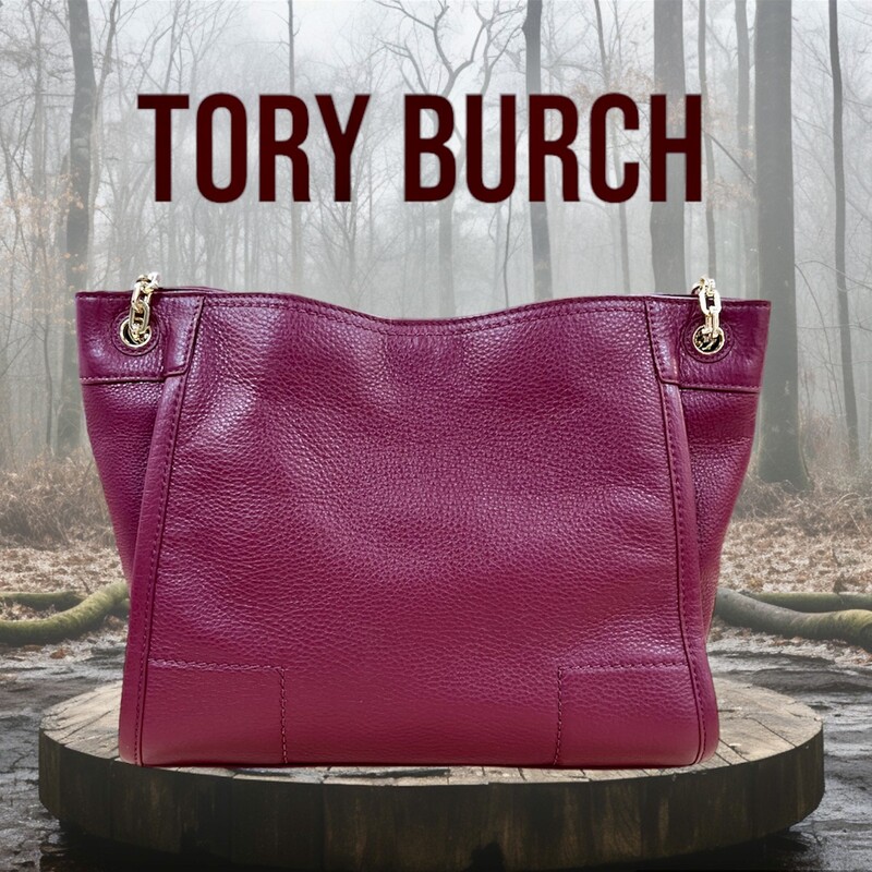 TORY BURCH<br />
Defined by a clean, versatile shape punctuated with a cut-out double-T logo, our new Britten Small Slouchy Tote is made of soft pebbled leather with chain-adorned straps. The roomy interior has multiple pockets, including a convenient center zip compartment that can fit a phone and a wallet. It’s graphic and polished, a great style for work or weekend.<br />
<br />
* Holds a 10\" tablet, a continental wallet, a notebook, sunglasses, an iPhone 6 Plus, a makeup compact and a lip color<br />
* Pebbled leather<br />
* Magnetic snap closure<br />
* Flat leather-and-chain double straps with 8.76\" (22 cm) drop when doubled<br />
* 1 interior center zipper compartment, 1 zipper pocket at back wall<br />
* Height: 9.56\" (24 cm)<br />
* Length: 11.75\" (29.5 cm)<br />
* Depth: 4.78\" (12 cm)<br />
This Handbag is in like new condition, with no marks, flaws or stains.  Absolutely Beautiful!<br />
Original Retail Price:  $475.00