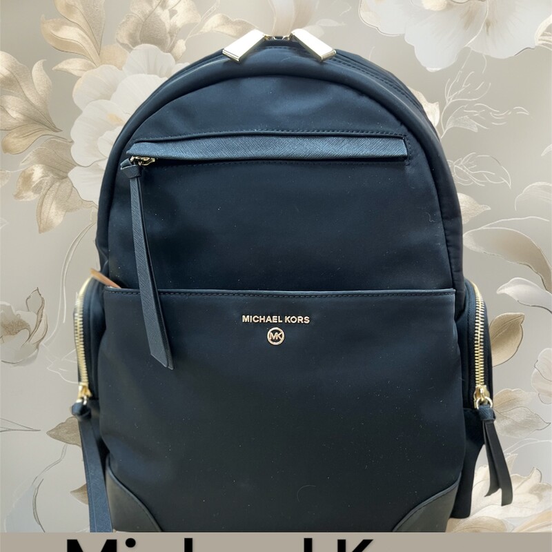 MIchael Kors Large black Nylon Backpack
Product Details:
-Zip closure
-1 BACK ZIP POCKET, 1 BACK SLIP POCKET
-2 FRONT SLIP POCKETS
-1 BACK ZIP TECH COMPARTMENT, 1 FRONT ZIP POCKET, 1 FRONT ZIP POCKET WITH 2 INTERIOR SLIP POCKETS, 2 SIDE ZIP POCKETS
-Top handle with 1.25 in drop
-Adjustable shoulder straps

Product Specifications:
11 W X 15.5 H X 6.75 D
Material & Care
Nylon
Clean with a soft cloth.
This backpack is in like new condition. No marks, stains or flaws.
Original Retail price:  $278.00
This backpack is currently available right now online & in stores for 278.00