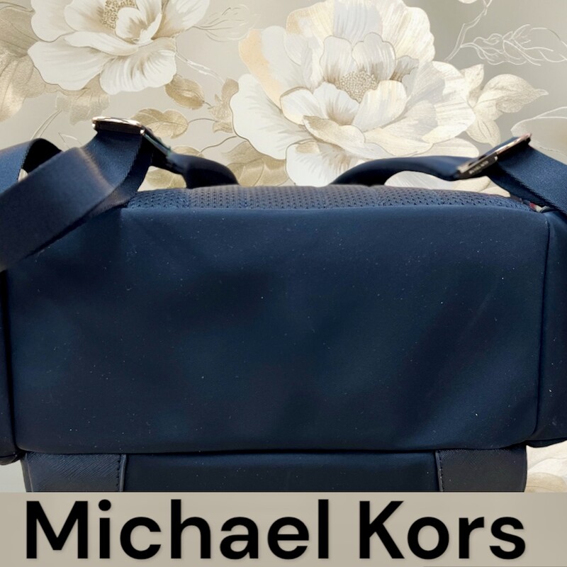 MIchael Kors Large black Nylon Backpack<br />
Product Details:<br />
-Zip closure<br />
-1 BACK ZIP POCKET, 1 BACK SLIP POCKET<br />
-2 FRONT SLIP POCKETS<br />
-1 BACK ZIP TECH COMPARTMENT, 1 FRONT ZIP POCKET, 1 FRONT ZIP POCKET WITH 2 INTERIOR SLIP POCKETS, 2 SIDE ZIP POCKETS<br />
-Top handle with 1.25 in drop<br />
-Adjustable shoulder straps<br />
<br />
Product Specifications:<br />
11 W X 15.5 H X 6.75 D<br />
Material & Care<br />
Nylon<br />
Clean with a soft cloth.<br />
This backpack is in like new condition. No marks, stains or flaws.<br />
Original Retail price:  $278.00<br />
This backpack is currently available right now online & in stores for 278.00