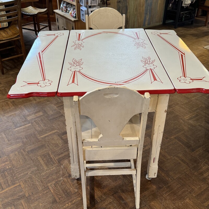 Beautiful Vintage Red and White Enamel Table
with Two Wooden Chairs.
45 In Width (Open) x 24 In Width (Closed) x 40 In Length x 31 In Tall.