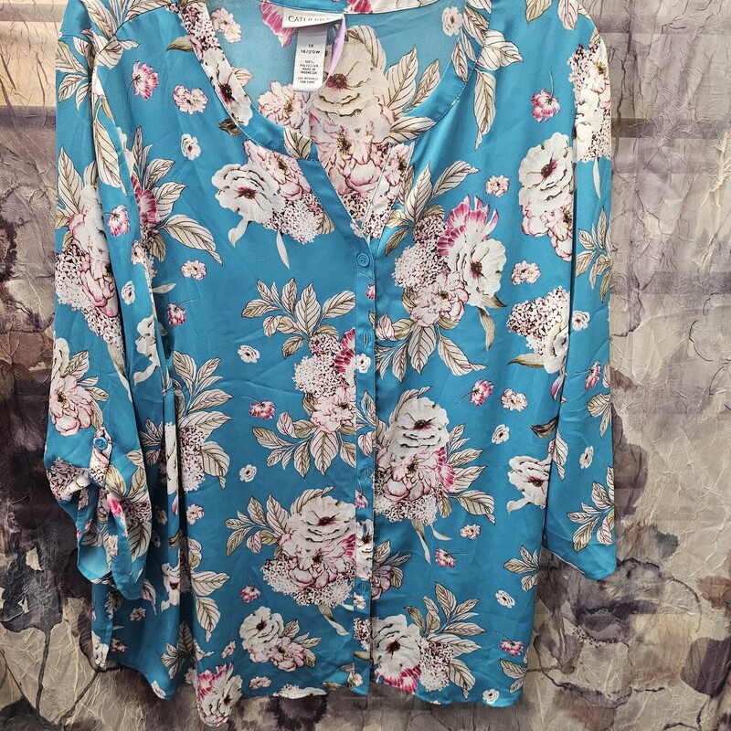 Button up front blouse in bright blue with floral print and half sleeves.