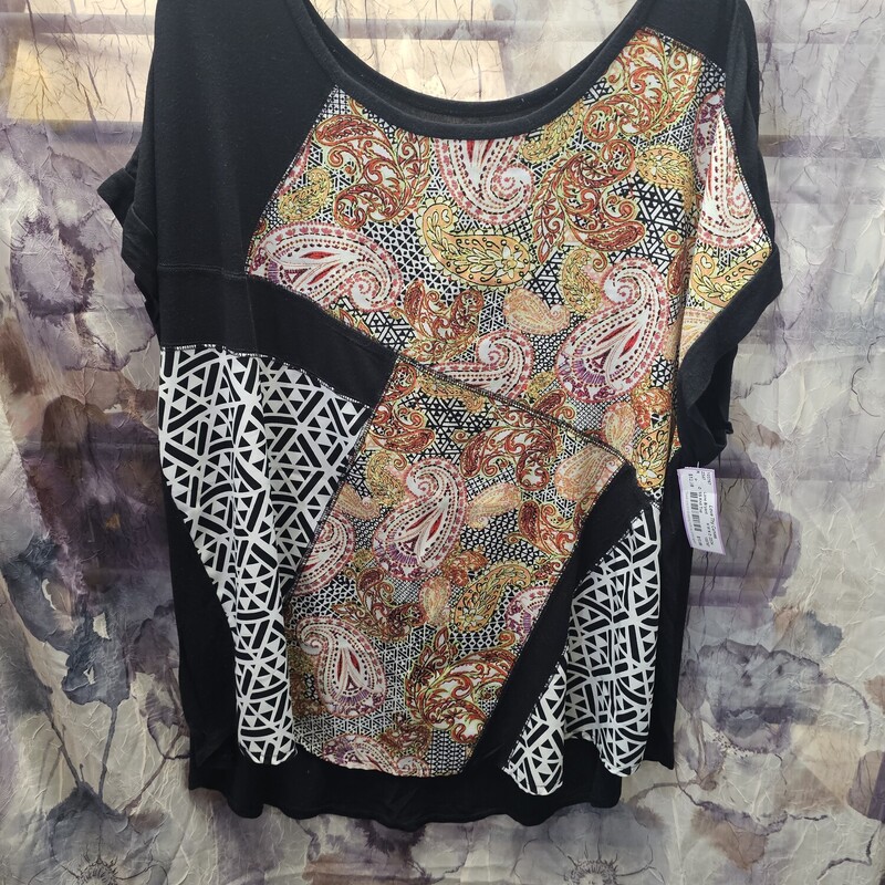 Fun cap sleeve blouse in black knit with blouse type panel in a fun print on the front only. Can be dressed up under a blazer or paired with jeans for dressing down style.