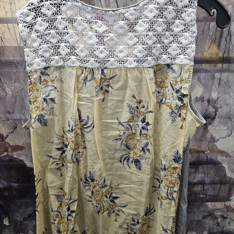 Super cute tank with grey knit in front and poly panel in the back in yellow with floral print.