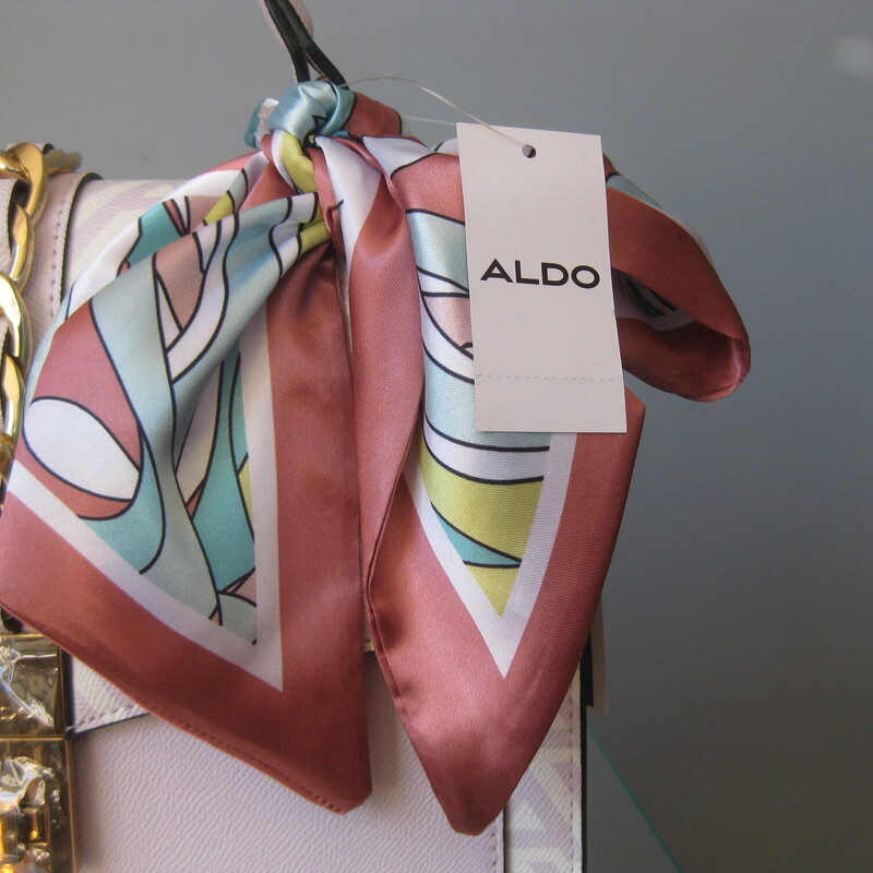 NWT Aldo Satchel, Lavender, Size: None<br />
Darling and chic little satchel by ALDO<br />
It's faux leather, sturdy and stands up by itself.<br />
It has a single top handle and a gold chain crossbody strap<br />
flap entry with turn lock closure<br />
zippered pocket on the outside<br />
two slip pockets and a zippered pocket inside.<br />
decorated with a cute scarf.<br />
10.5 x 8 x 3.5 deep at the bottom and about 2 at the top<br />
<br />
perfect brand new condition with tags<br />
thanks for looking!<br />
#72696