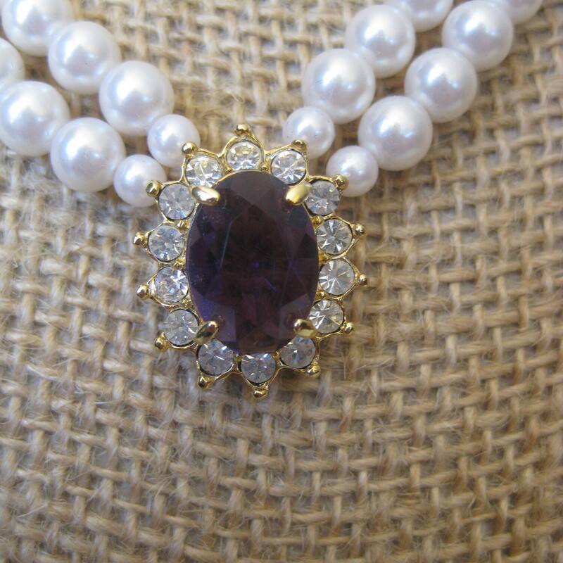 Avon Faux Pearl Set, Purple, Size: None<br />
Vintage Avon Jewelry Set<br />
a double strand of faux pearls with a central amethyst colored stone surrounded by rhinestones set in gold tone metal.<br />
the set comes with a pair of stud earrings consisting of a garnet colored stone surmounted by a round rhinestone.<br />
<br />
the necklace has a hook clasp and measures 23 in total length<br />
the earrings are about 1/2 long<br />
<br />
box is original but a little beat up as shown.<br />
<br />
thanks for looking!<br />
#72699