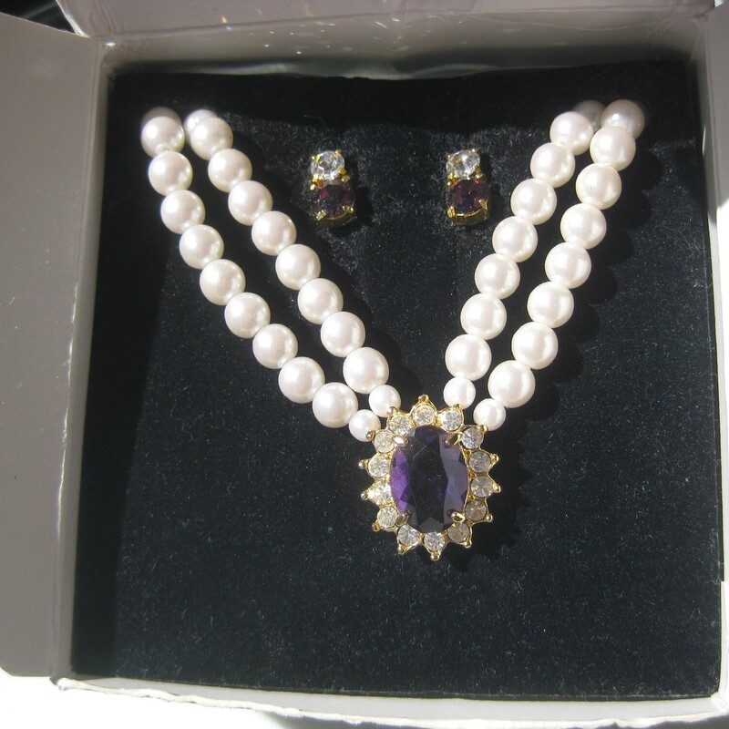 Avon Faux Pearl Set, Purple, Size: None<br />
Vintage Avon Jewelry Set<br />
a double strand of faux pearls with a central amethyst colored stone surrounded by rhinestones set in gold tone metal.<br />
the set comes with a pair of stud earrings consisting of a garnet colored stone surmounted by a round rhinestone.<br />
<br />
the necklace has a hook clasp and measures 23 in total length<br />
the earrings are about 1/2 long<br />
<br />
box is original but a little beat up as shown.<br />
<br />
thanks for looking!<br />
#72699