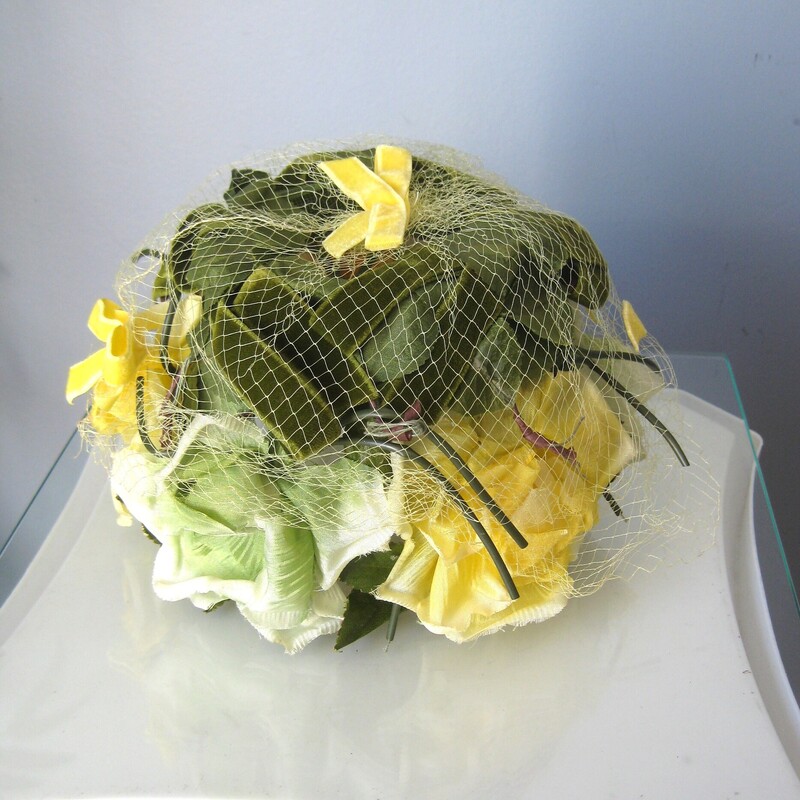 Here is a pill box hat made out of a green flexible plastic cage covered with yellow fabric flower and green fabric leaves.
It measures just 18 around at the opening, but since the cage or frame is flexible you can push it down on whatever part of the head you wish and then pin it in place to keep it there.
no labels
excellent vintage condition, no flaws

thanks for looking!
#72873