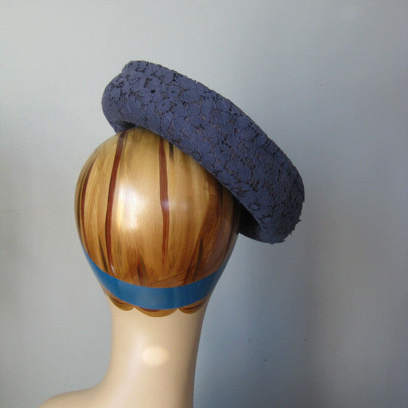 This is a flat round hat made from a stiff body and a blue lace covering.<br />
It's by Gigi.<br />
You'll need a pin or two to secure it into your hair and you can wear it tilted, towards the front or the back.<br />
It's medium navy blue<br />
Excellent condition, no flaws<br />
<br />
The hat measures 20.5 around the inner hat band.<br />
thanks for looking!<br />
#65544