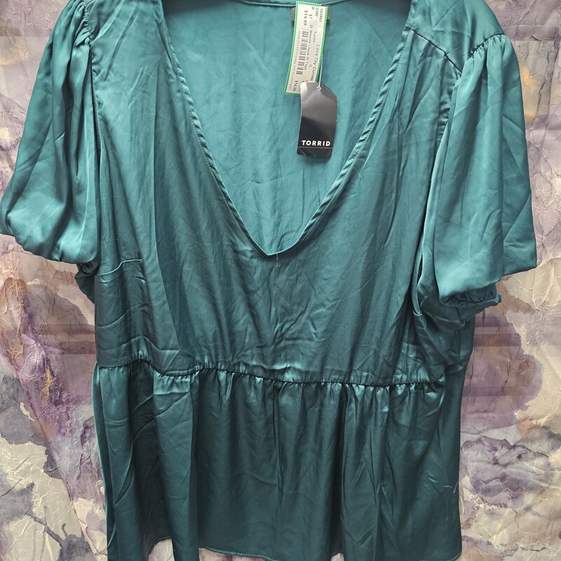Brand new with tags, this blouse is done in a satiny emerald green and is super cute for year round wear.