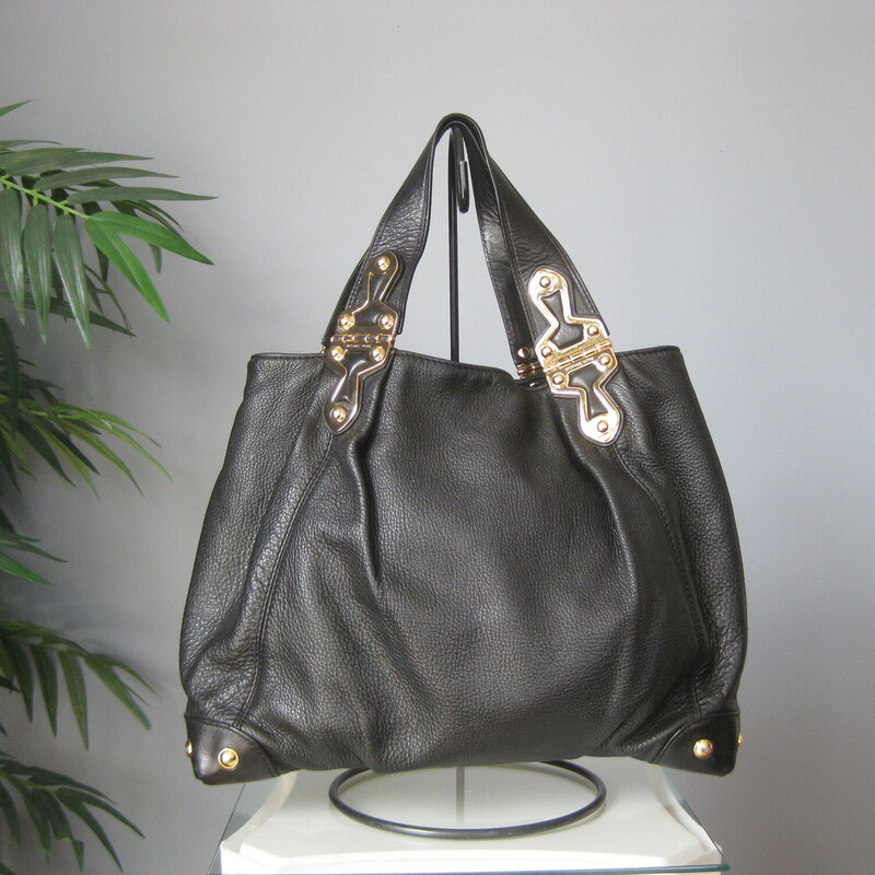 Michael Kors Pebbled, Black, Size: N<br />
Edgy looking black leather satchel from Michael Kors<br />
Super shiny and chunky gold hardware<br />
two handles<br />
four slip pockets inside and one zip pocket<br />
<br />
16 x 12 x 4.5<br />
handle drop: 6.5<br />
<br />
excellent pre-owned condition.<br />
<br />
#72726