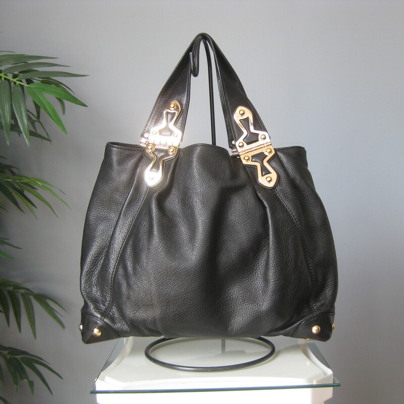 Michael Kors Pebbled, Black, Size: N<br />
Edgy looking black leather satchel from Michael Kors<br />
Super shiny and chunky gold hardware<br />
two handles<br />
four slip pockets inside and one zip pocket<br />
<br />
16 x 12 x 4.5<br />
handle drop: 6.5<br />
<br />
excellent pre-owned condition.<br />
<br />
#72726