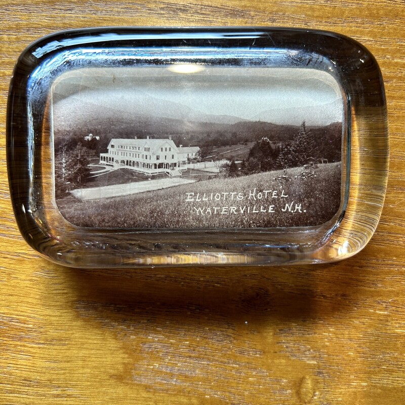Elliots Hotel WV Paperweight
Size: 4 X 2 1/2
Sepia color photo of the Elliots Hotel circa 1883  Great historic piece. In excellent condition.
THE ELLIOTT HOUSE, formerly the Greeley House, Silas B. Elliott, proprietor,cares well for these tourists who come here to enjoy nature in one of her
wildest phases. The hotel is located at the extreme head of Mad river valley,and twelve miles from Campton, the nearest railroad station, to which a stage
runs daily during the summer season.  This hotel was established as early as1831, by Nathaniel Greeley, when guests were obliged to walk a long distance
to reach the house. Mr. Greeley and his sons continued the business until1884, when it was taken by the present firm.  Views of some of the finest scenery in the mountains may be obtained from the surrounding peaks. Thereare also ten trout brooks within a day's fishing.