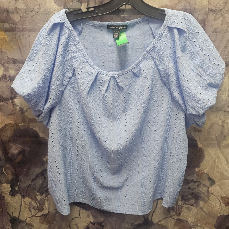 Blue blouse in a lightweight linen with embroidery and die cut design.