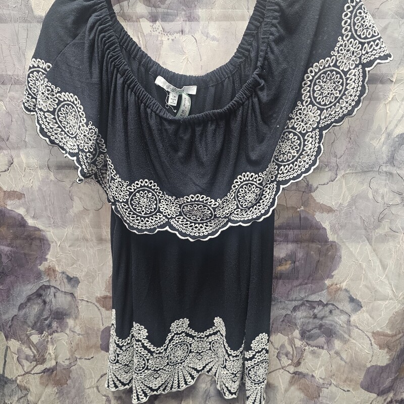 Halter style knit top in black with white embroidered design