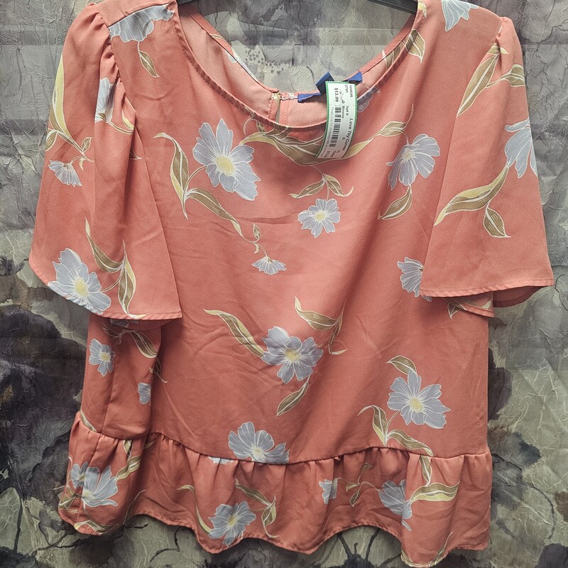 Half sleeve blouse in a soft orange with blue floral print.