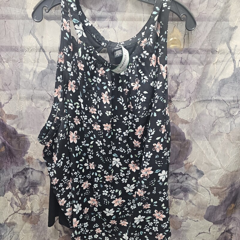 Sleeveless blouse in black with floral print.