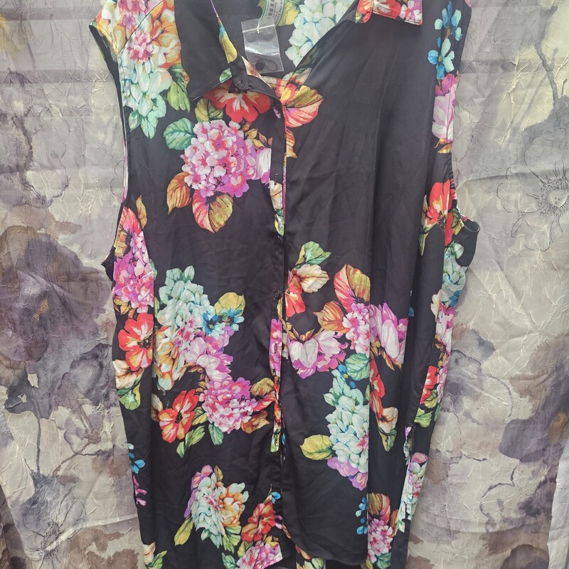Sleeveless blouse in black with floral print and button up front. Super long style.