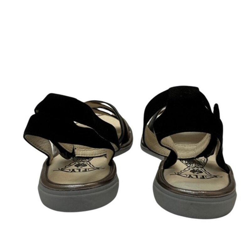 New Fly London CUNE Sandals<br />
Ground control. This low-heeled sandal keeps pace with your busy flight patterns this summer! From FLY London.<br />
Multi-strap upper, hook-and-loop closure on ankle strap<br />
Padded insole<br />
Approximately 3/4H sole<br />
Fit: true to size<br />
Leather upper; man-made balance<br />
Contains latex<br />
Color: Black and Gold<br />
Size: 8.5