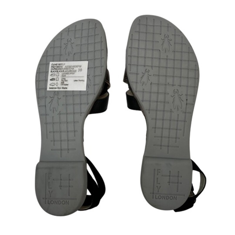 New Fly London CUNE Sandals<br />
Ground control. This low-heeled sandal keeps pace with your busy flight patterns this summer! From FLY London.<br />
Multi-strap upper, hook-and-loop closure on ankle strap<br />
Padded insole<br />
Approximately 3/4H sole<br />
Fit: true to size<br />
Leather upper; man-made balance<br />
Contains latex<br />
Color: Black and Gold<br />
Size: 8.5