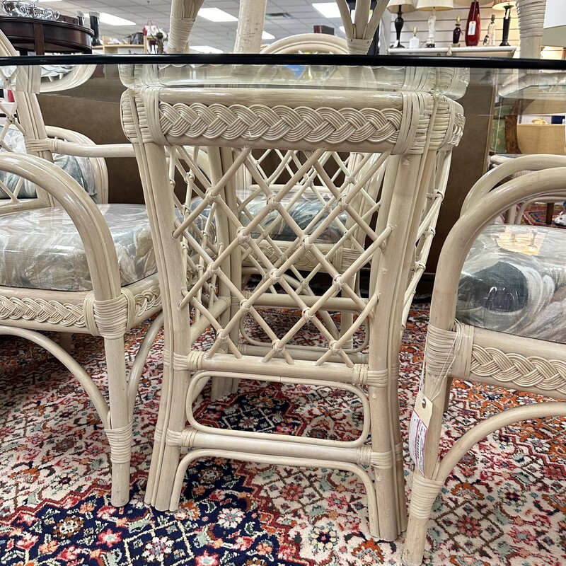 Benchcraft Rattan Dining set, includes the round glass top table and five upholstered cushioned chairs.