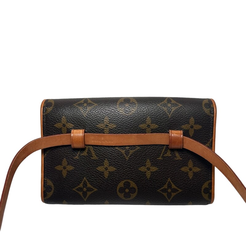 LOUIS VUITTON Monogram Pochette Florentine size M. The stylish bag is a simple small flap style pouch that is crafted of classic Louis Vuitton monogram on coated canvas with signature vachetta natural cowhide. This bag features an optional strap for around the waist and polished gold hardware. The interior is a beige microfiber.
Code: FL0073
Dimensions:
Base length: 6.5 in
Height: 4.25 in
Width: 1.75 in
Drop: 20 in