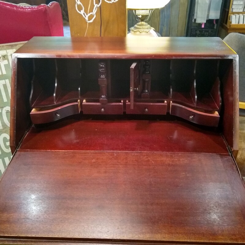 Mahogany Secretary Desk<br />
<br />
Mahogany Secretary Desk in good condition.  Front of desk has 4 serpentine style drawers.  Top drops down and inside is 4 small drawers with 6 cubbies and 1 middle door that opens.  Very nice piece!