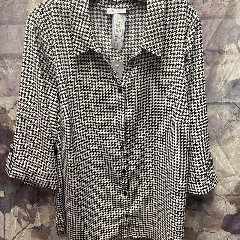 Button up half sleeve blouse in black and white that is brand new with tags and retails for $50