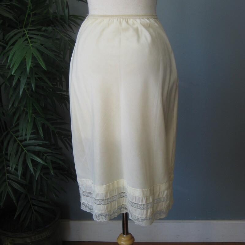 Vtg Barbizon Half Slip, Ivory, Size: Medium<br />
Pretty half slip in yellowy cream with tiers of lace trim.<br />
two slits<br />
Good vintage condition, plenty of snap to the elastic waist<br />
It has some discolorations, pls see last photo.  very faint.<br />
100% Nylon, made in the USA<br />
by Barbizon<br />
<br />
You can wear the slip with the slit in any position so it will work with any skirt or dress that has a slit, whether it's in the front back or side.<br />
<br />
Here are the flat measurements:<br />
Waist : 11.5 stretches comfortably to 14.<br />
Hip: 16<br />
Length: aprox. 25<br />
slits: 5<br />
<br />
 Thank you for looking.<br />
#71630