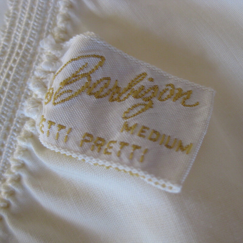 Vtg Barbizon Half Slip, Ivory, Size: Medium<br />
Pretty half slip in yellowy cream with tiers of lace trim.<br />
two slits<br />
Good vintage condition, plenty of snap to the elastic waist<br />
It has some discolorations, pls see last photo.  very faint.<br />
100% Nylon, made in the USA<br />
by Barbizon<br />
<br />
You can wear the slip with the slit in any position so it will work with any skirt or dress that has a slit, whether it's in the front back or side.<br />
<br />
Here are the flat measurements:<br />
Waist : 11.5 stretches comfortably to 14.<br />
Hip: 16<br />
Length: aprox. 25<br />
slits: 5<br />
<br />
 Thank you for looking.<br />
#71630