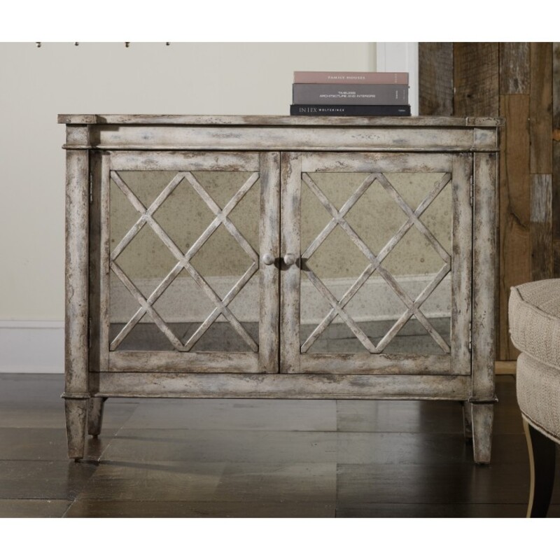 Hooker Melange Blanca Villa Console<br />
Gray Silver Size: 44 x 20 x 34H<br />
Retails: $952+<br />
Antique mirror on doors<br />
Lattice design<br />
2 doors with 1 adjustable shelf behind doors<br />
3 plug outlet<br />
Hardwood Solids and Antique Mirror