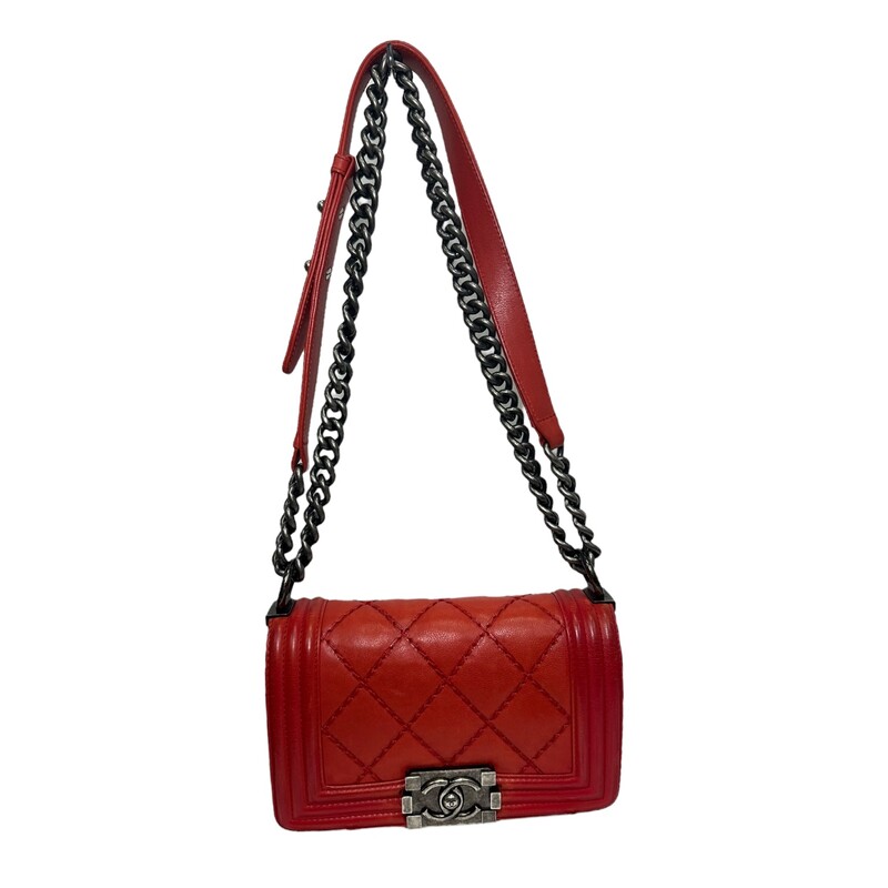 CHANEL Calfskin Double Stitch Small Boy Flap in Red. Thisshoulder bag is crafted of rich calfskin leather in red. The bag features a ruthenium chain shoulder strap with a leather shoulder pad, a diamond-stitched crossover flap with linear quilted borders, and a ruthenium CC boy push lock. This opens to a gray fabric interior with patch pocket.<br />
Some Minor Corner wear<br />
Code:1876082<br />
Production year: 2013-2014<br />
Dimensions:<br />
Base length: 9.75 in<br />
Height: 5.75 in<br />
Width: 3.25 in<br />
Drop: 11.5 in<br />
Drop: 20.25 in