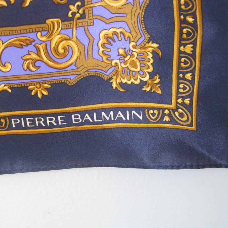 Pierre Balmain Sm Silk Sq, Blue, Size: 22.5 Sq<br />
Pretty silk sqaure by Parisian designer Pierre Balmain.<br />
 Navy blue with pink yellow teal and periwinkle leaves and flowers surrounded by gold scroll elements<br />
silk twill<br />
22.5 square.<br />
<br />
Excellent vintage condition, no flaws<br />
<br />
thanks for looking!<br />
#74011