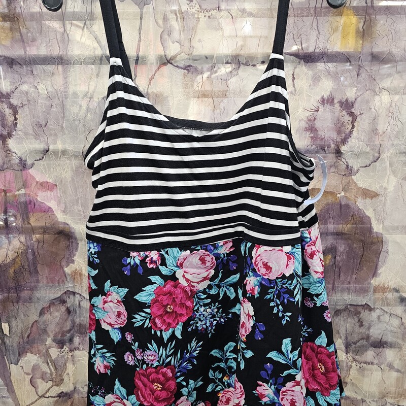 Super cute summer tank with black and white stripe bust area and a floral print on black background bottom flaired half.