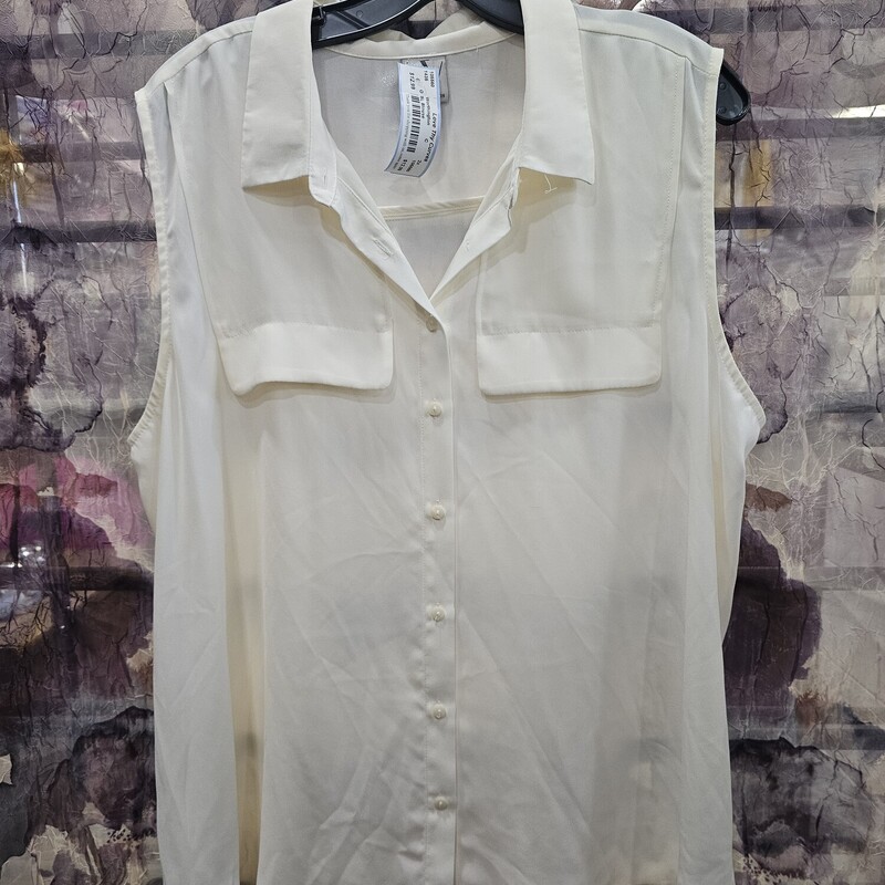 Sleeveless blouse with button up front in a creamy color.