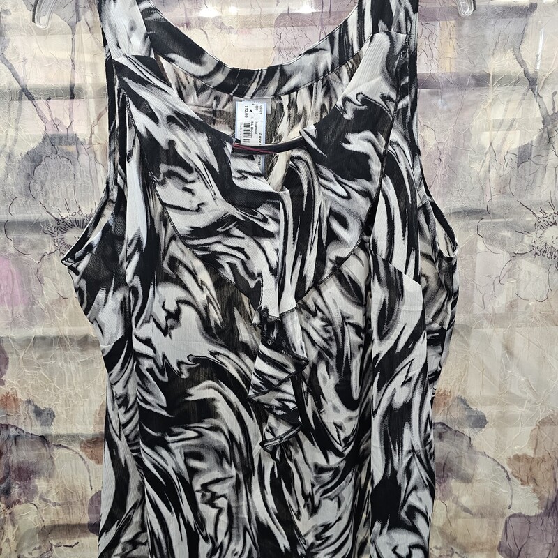 Tank style sleeveless blouse in black and white pattern with ruffle front.