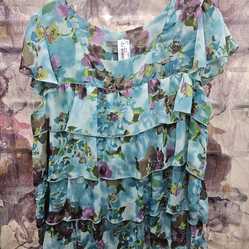 Sleeveless blouse in blue with floral print and alllllll the ruffles.