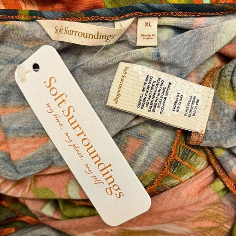 New Soft Surround Fabiana<br />
Rouille Palm Print<br />
Sleeveless<br />
Smocked Detail<br />
Slight Hi-Lo Ruffle Bottom<br />
Rayon & Spandex<br />
Spice with Olive Green, Gray, Peach and Aqua<br />
Size: XL<br />
Retails for $120.00