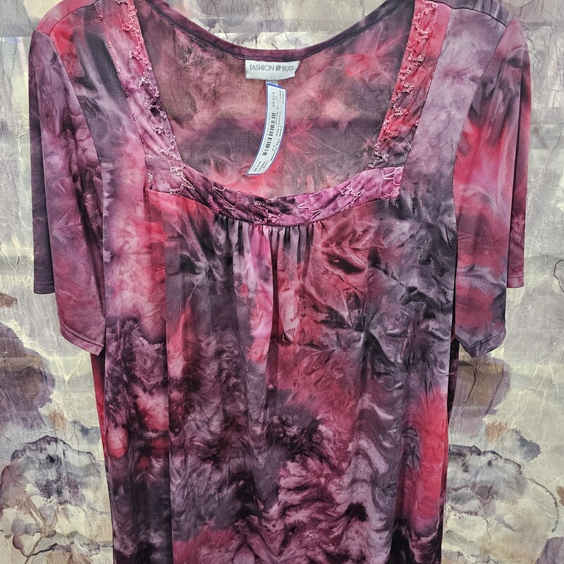 Short sleeve blouse in a purple burgandy and black print.