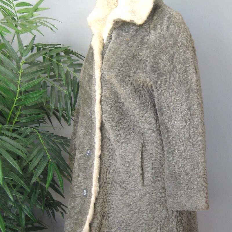 Vtg Faux P. Lamb, Gray, Size: Small<br />
Nice faux persian lamb coat in gray.  It's has a Faux shearling collar and facings.<br />
It good vintage condition.  Not perfect<br />
It could use a new lining<br />
The faux fur is a little rough to the touch.<br />
Make sure it fits you and it will be comfortable and fun to wear.<br />
And Warm.<br />
Union label and a 60s style brand/store label<br />
Fancy buttons, and an extra one on the inside.<br />
pockets<br />
<br />
flat measurements:<br />
armpit to armpit:  20.5  (taken on the inside of the coat)<br />
length: 32 , will probably hit above your kneed<br />
waist area: 23<br />
hip area: 24<br />
underarm sleeve seam length: 14.5, this is a 'bracelet' length, designed to show off longer gloves and arm candy<br />
<br />
thanks for looking!<br />
#70403