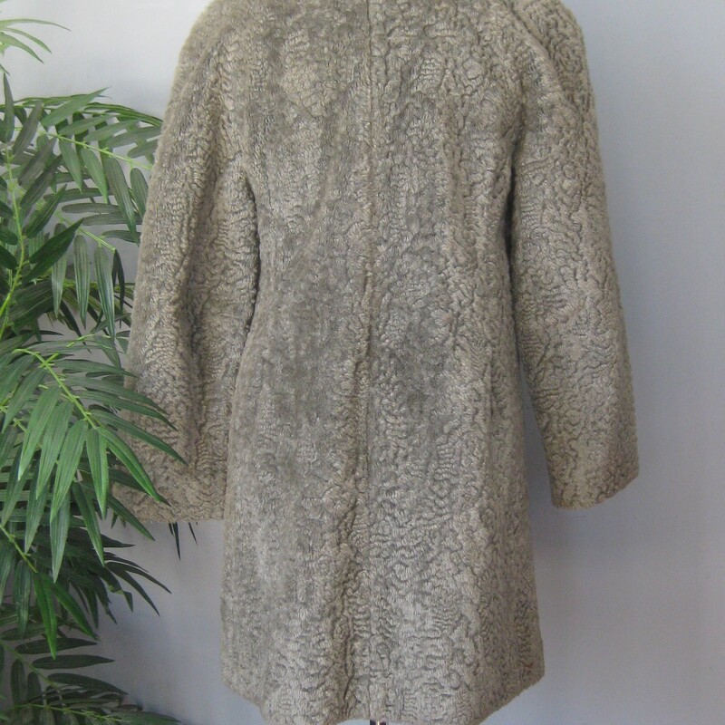 Vtg Faux P. Lamb, Gray, Size: Small<br />
Nice faux persian lamb coat in gray.  It's has a Faux shearling collar and facings.<br />
It good vintage condition.  Not perfect<br />
It could use a new lining<br />
The faux fur is a little rough to the touch.<br />
Make sure it fits you and it will be comfortable and fun to wear.<br />
And Warm.<br />
Union label and a 60s style brand/store label<br />
Fancy buttons, and an extra one on the inside.<br />
pockets<br />
<br />
flat measurements:<br />
armpit to armpit:  20.5  (taken on the inside of the coat)<br />
length: 32 , will probably hit above your kneed<br />
waist area: 23<br />
hip area: 24<br />
underarm sleeve seam length: 14.5, this is a 'bracelet' length, designed to show off longer gloves and arm candy<br />
<br />
thanks for looking!<br />
#70403