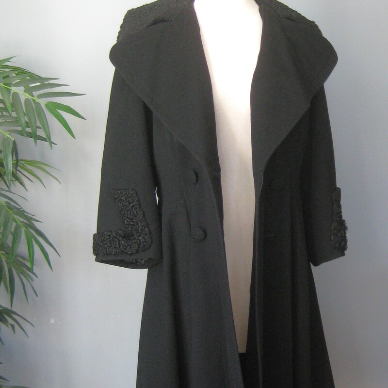 Vtg 40s Wool P. Lamb, Black, Size: Small
This gorgeous black coat from the 1940s or 50s features a large collar and cuffs trimmed in black persian lamb, a fitted waist and a full skirt. It has an attached half belt across the back waist.    It has four buttons arranged in double breasted style.  The fabric is smooth wool.   Fully lined with pockets.  the lining is a charmuese satin and between it and the outer body of the coat is a thick insulation layer.
 So this coat is built for style and function and will keep you toasty warm in any weather.

The dramatic silhouette works for day or evening looks.

Here are the flat measurements, please double where appropriate:
Should to shoulder: 17
Armpit to Armpit: 21.5
Waist: 18
Hip: 25.5
Length: 40.25

Excellent vintage condition, no flaws!
Thank you for looking.
#70405