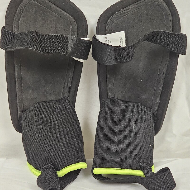 Athletic Works Youth Stirrup Soccer Shin Guards<br />
Size: Small<br />
Color: White/Black/Neon Yellow<br />
Pre-Owned: Excellent Condition<br />
Barely Used. Straps are in excellent condition, not stretched out.  Foam backing is in perfect condition.