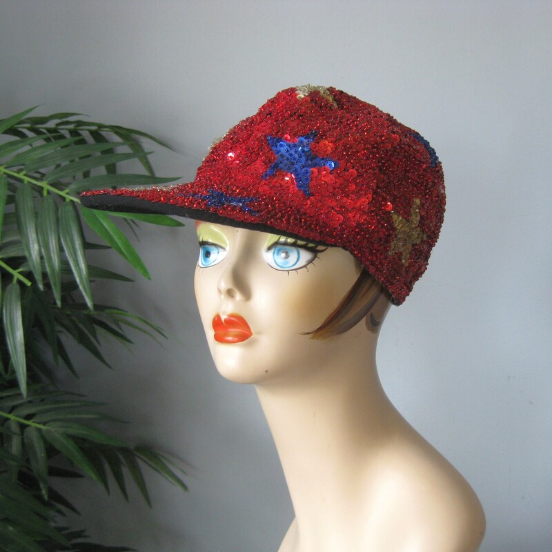 Sequined Cap W Stars, Red, Size: None<br />
Super fun street style baseball cap completely covered in sequins.<br />
It's red with different colored stars all over it.<br />
The center back has a bit of elastic so it should fit anyone.<br />
Fits me comfortably and my head is around 22 around (a little on the big side )<br />
great shape.<br />
thanks for looking!<br />
#74914