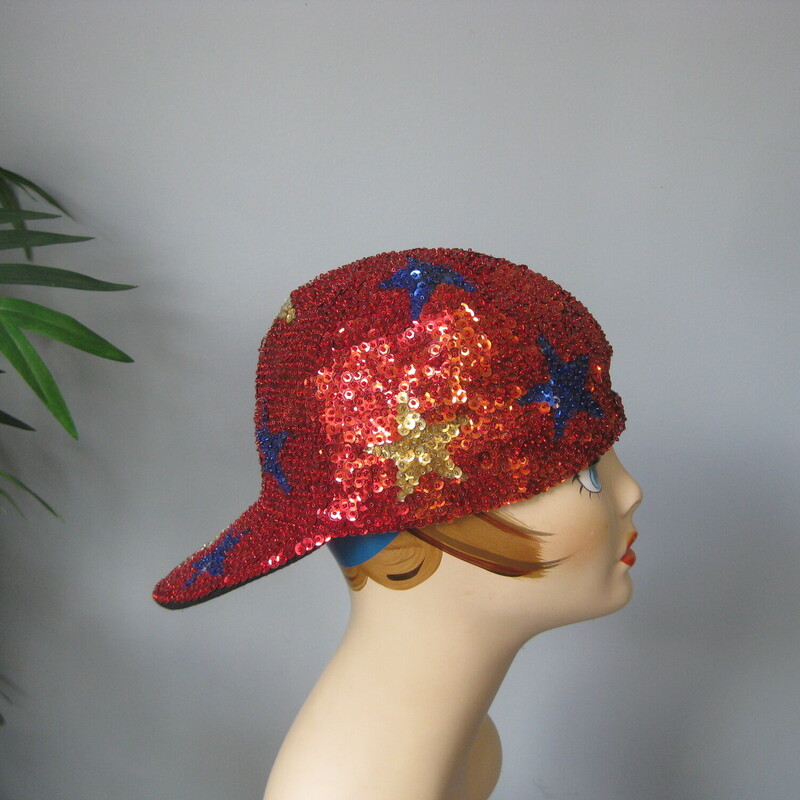 Sequined Cap W Stars, Red, Size: None<br />
Super fun street style baseball cap completely covered in sequins.<br />
It's red with different colored stars all over it.<br />
The center back has a bit of elastic so it should fit anyone.<br />
Fits me comfortably and my head is around 22 around (a little on the big side )<br />
great shape.<br />
thanks for looking!<br />
#74914