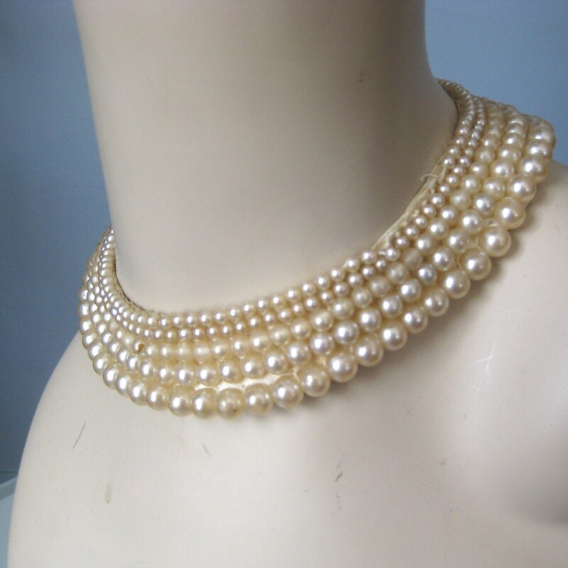 Pearl Collar, White, Size: None<br />
This is a pretty faux pearl collar from the 1950s, it is fabric backed and has pretty dangly strings of pearls  at the ends where there is a hook and eye closure.<br />
<br />
These chokers look amazing on modern girls and would make a great vintage gift.<br />
15.5 end to end<br />
<br />
This one is in fair condition and is priced accordingly.<br />
The finish has rubbed off on some of the pearls, especially the dangly ones at the back. There is a one inch section at one edge that is missing pearls<br />
Still totally wearable and pretty.<br />
Thanks for looking.<br />
#50952