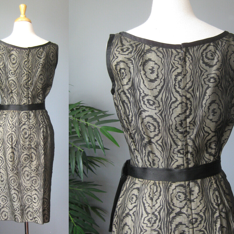 Vtg 50s Silk Print, Blk/gray, Size: Small<br />
Sophisticated cocktail dress from the 1950s.  This is a custom handmade dress.<br />
It was made from a black and white abstract swirl print cotton or cotton silk blend overlain with sheer black organza.  Fitted and offering high end dressmaker details like a waist and bra bra stays and bound armholes.  It also has a deep hem, 4 1/8, this deep hem provides stability and a bit of weight at the bottom, not that this dress is liable to fly up in any wind, it's too fitted for that!<br />
<br />
Center back black metal zipper.<br />
beautifully fringed attached satin belt.<br />
<br />
This dress fits my size 4 mannequin perfectly but without a lot of room to spare.<br />
Here are the flat meausurements:<br />
armpit to armpit: 18.5<br />
waist: 13<br />
hip: 18.75<br />
length: 38<br />
<br />
Excellent condition, no flaws.<br />
thanks for looking!<br />
#70432