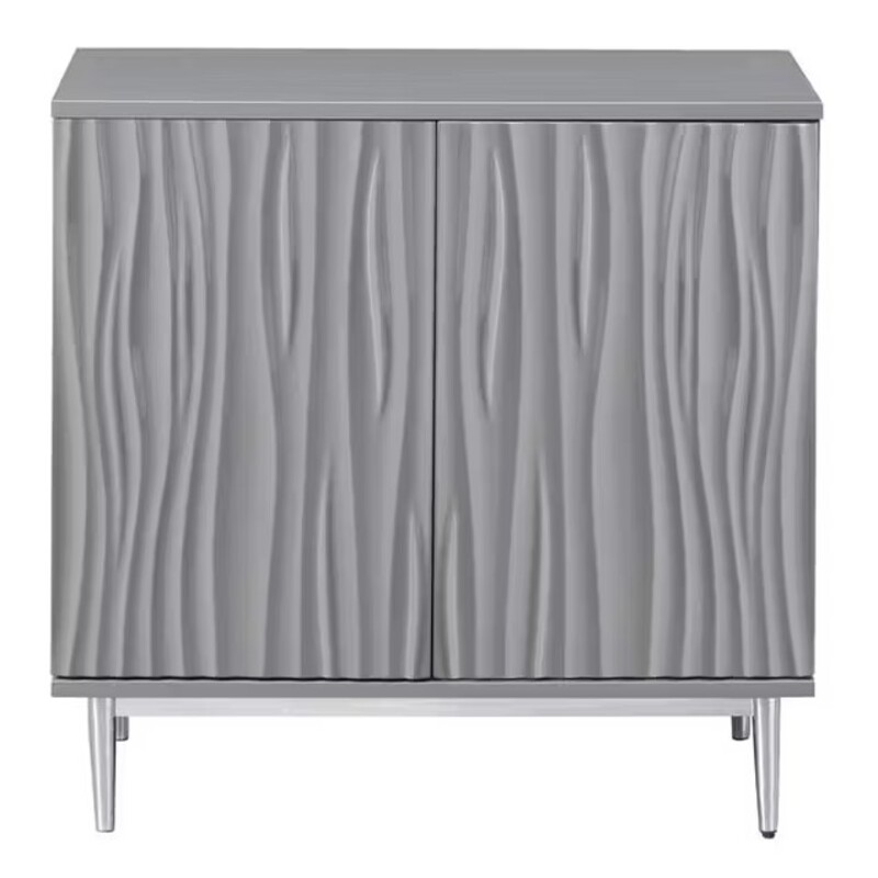 Wavy 2 Door Console
Gloss Grey with Silver Legs
Size: 32x16x32H
Coated in our Waves Glossy Grey, the linear sides beautifully frame the hi-relief flowing design of the two front doors, all of which are set off by the polished chrome angular base. With a spacious shelved interior, this Cabinet will make a wonderful addition to any decor.
NEW
Retail $925