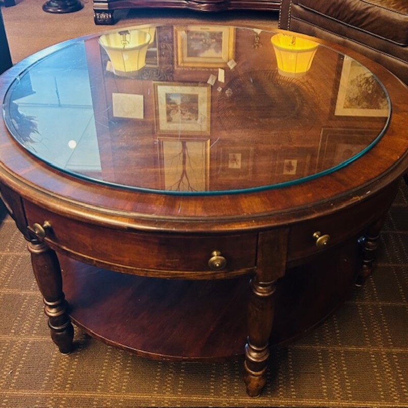 Mahogany Round Coffee Table with Glass Top
Brown Gold Size: 42 x 23H
Glass top is smaller than coffee table
6 drawers - 3 open and 3 do not